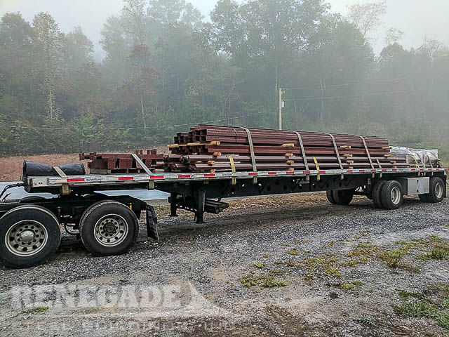 truck with red iron steel building load