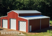 red barn style steel building with white trim, gutters and down spouts, large white roll up doors, white walk door, monitor roof
