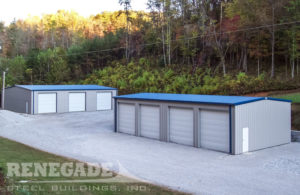 gray steel building with blue roof and trim, large white roll up doors, white walk door