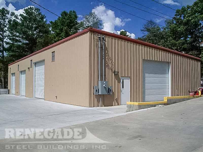 tan commercial steel building with red trim