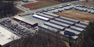 red steel building metal building self storage mini with white roll up doors, multi unit