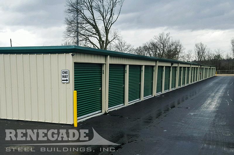 mini self storage steel building with green trim, roll up doors, 8 units