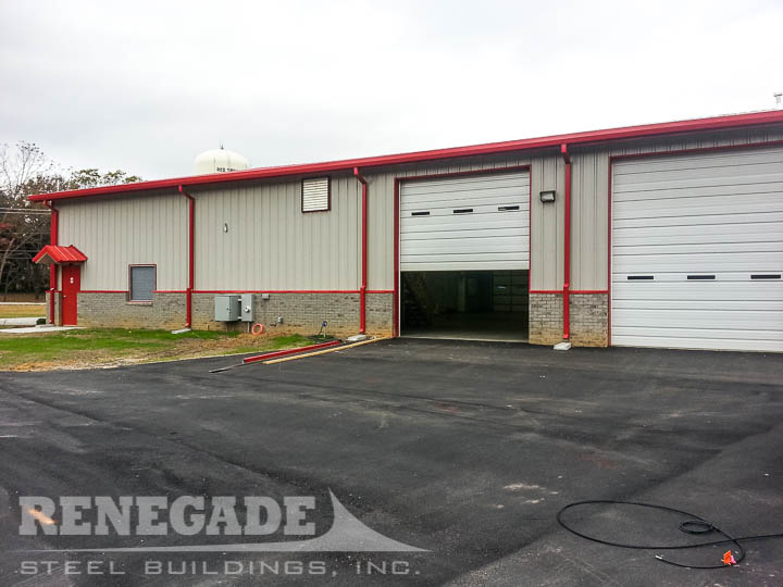 Tan steel building with red trim and brick wainscot, fire station, rescue squad