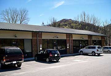 Strip mall steel building with brick and storefront glass