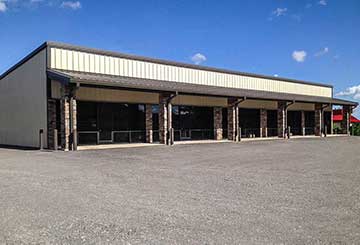 Strip mall steel building with awning, brick and storefront glass