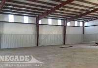 Renegade Steel Building interior with Standard insulation, wall liner panels, and wall lights