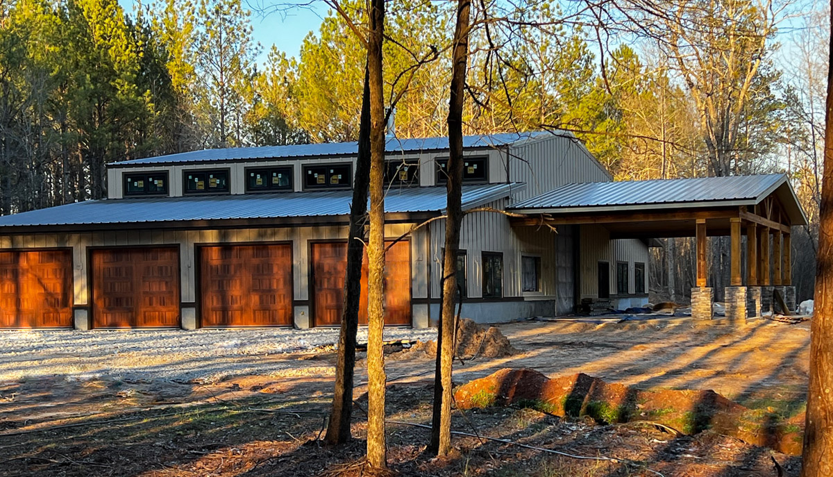 Steel building barndominium home with lean tos and covered porch