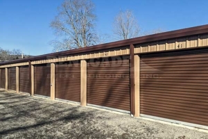 Renegade steel building mini warehouse with tan walls and bronze trim and rollup doors