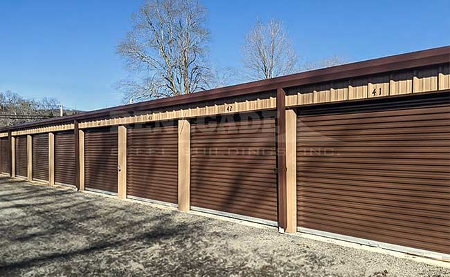 Renegade steel building mini warehouse with tan walls and bronze trim and rollup doors