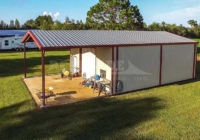 30x60x14 Renegade Steel Building with white walls, red trim, roll up door and open bay