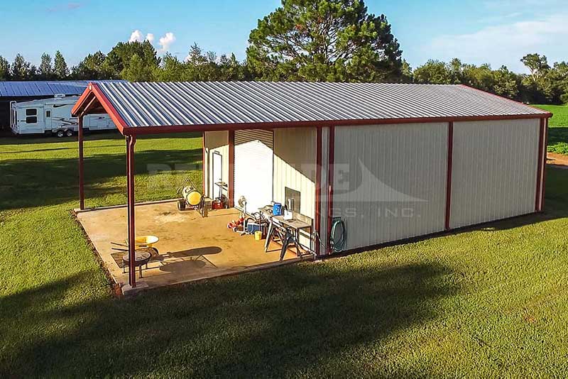 30x60x14 Renegade Steel Building with white walls, red trim, roll up door and open bay
