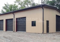 30x50x15 Renegade Steel Building with tan walls and brown trim including 4 large roll up doors
