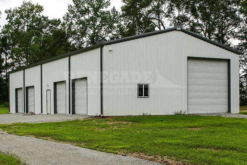 40x80x16 Renegade Steel Building with white walls and green trim, has 5 large roll up doors