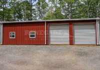 30x50x12 Renegade Steel Building with red walls, white trim, 2 10x10 roll up doors, walk doors and windows
