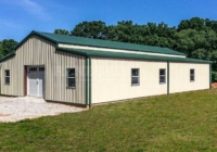 40x60x10/13 Tan steel metal building barn with green raised center roof (monitor style), windows and door