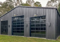 50x50 Renegade steel building with black walls and trim and large glass doors.