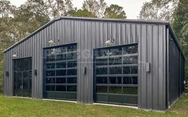 50x50 Renegade steel building with black walls and trim and large glass doors.