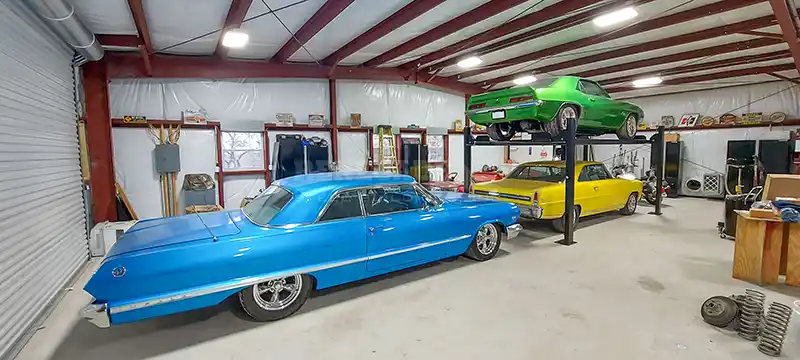 50x50x12 Renegade Steel Building Garage inside with cars on racks