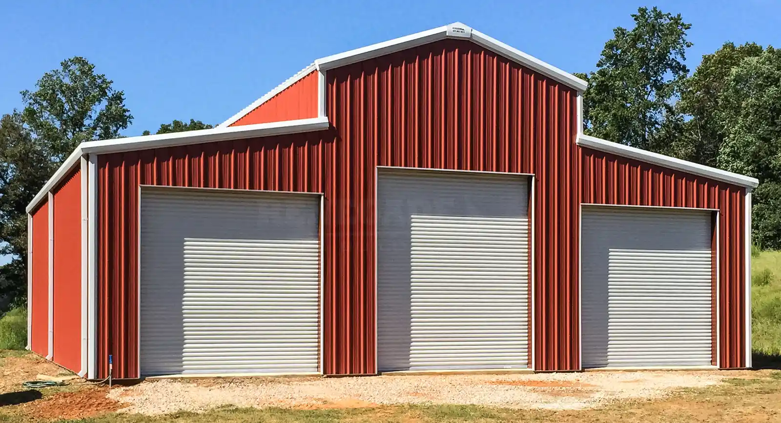 50x50 steel farm building with traditional red siding and white trim