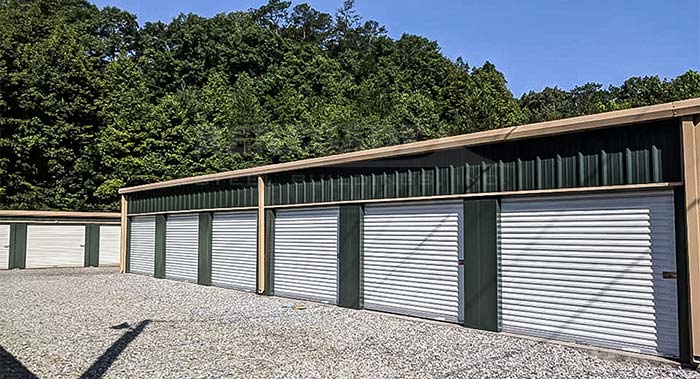 Self Storage steel building with green walls, tan trim and white doors