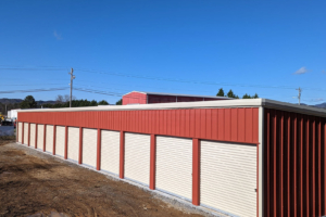 Self Storage building by Renegade, with red wall panels and white roll up doors.