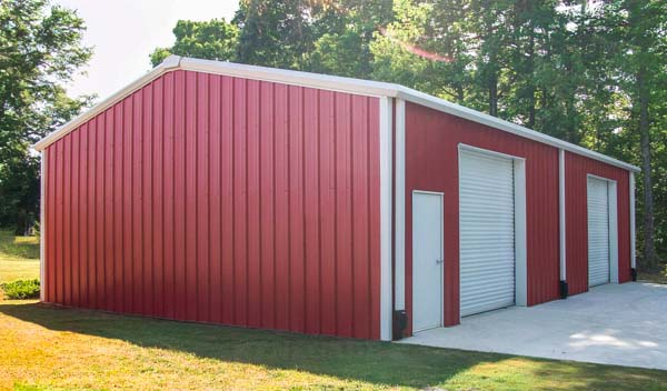 Red 30x40 metal building with white trim and doors