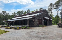 Monitory style steel building with rustic wood walls for a classic barn look.